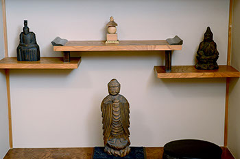 A shelf with two shelves hung at different angles from the left and right sides